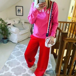 White UBUNTU on bright pink sweatshirt