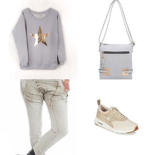 Metallic gold star on a light grey sweatshirt