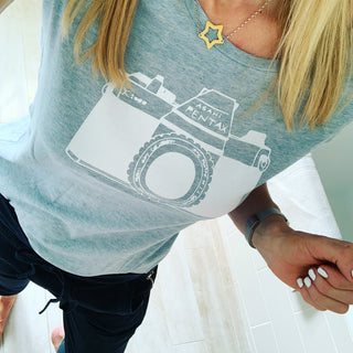 White camera on blue tee