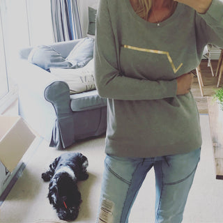 Gold diagonal stripe on light grey sweatshirt