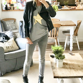 Metallic gold star on a light grey sweatshirt