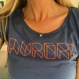 Neon orange Aurora triangle font on denim blue tee