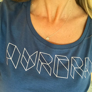 Pink geometric aurora font on denim blue tee