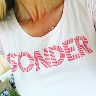 Red SONDER on pink tee
