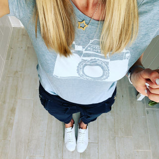 White camera on blue tee