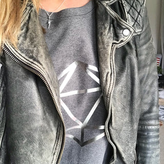 Metallic silver octahedron on a dark grey sweat