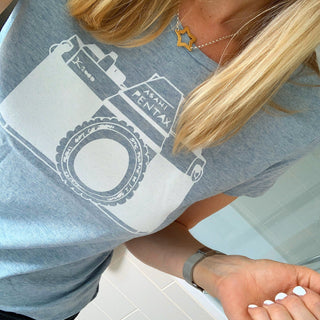 White camera on blue tee