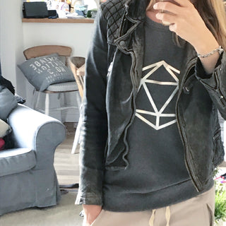 Metallic silver octahedron on a dark grey sweat
